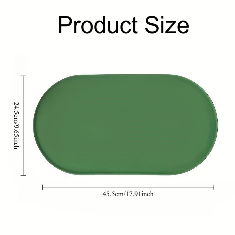Tapete oval verde para alimentação com bordas elevadas; o diagrama do fornecedor indica aproximadamente 45,5 por 24,5 cm.